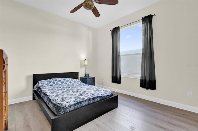 bedroom with hardwood / wood-style flooring and ceiling fan