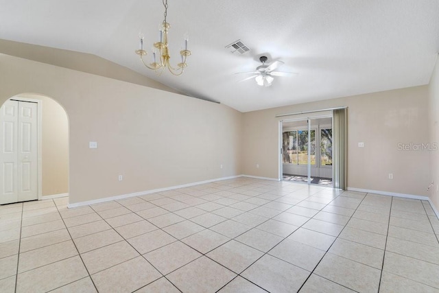 tiled spare room with ceiling fan with notable chandelier and lofted ceiling