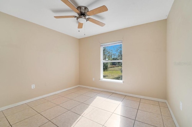 unfurnished room with ceiling fan and light tile patterned flooring