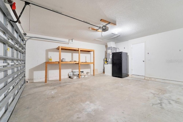 garage featuring black refrigerator and a garage door opener