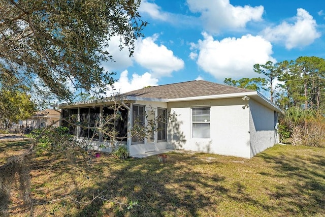 rear view of property with a yard