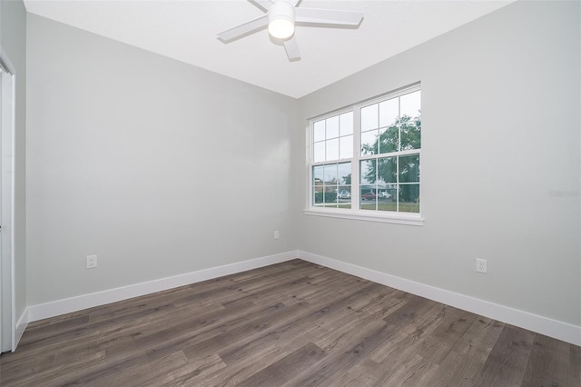 empty room with dark hardwood / wood-style flooring and ceiling fan