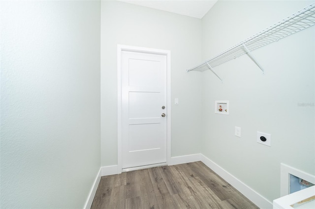 washroom with electric dryer hookup, hookup for a washing machine, and light hardwood / wood-style floors