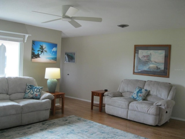 living room featuring hardwood / wood-style flooring and ceiling fan