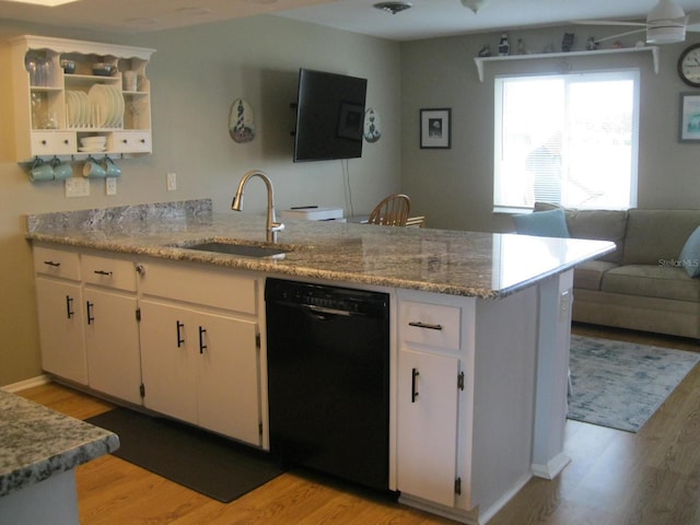 kitchen with kitchen peninsula, sink, white cabinets, and black dishwasher