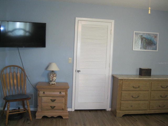 bedroom featuring dark hardwood / wood-style flooring