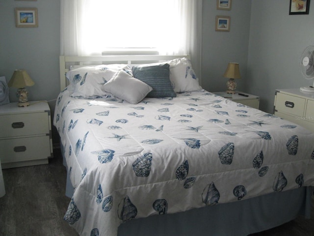 bedroom with dark wood-type flooring