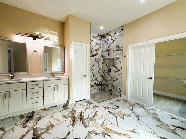 full bath featuring a sink, a marble finish shower, marble finish floor, and double vanity