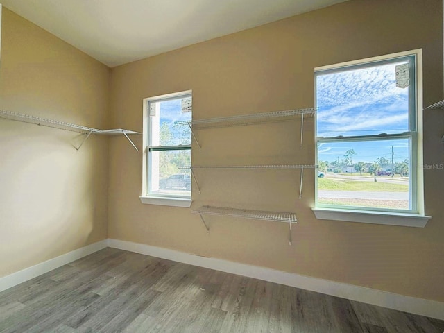 interior space with baseboards and wood finished floors