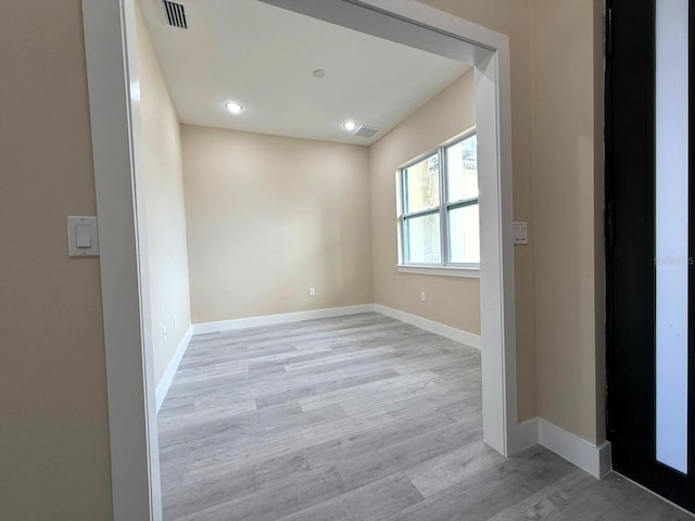 empty room with visible vents, recessed lighting, baseboards, and light wood-style floors