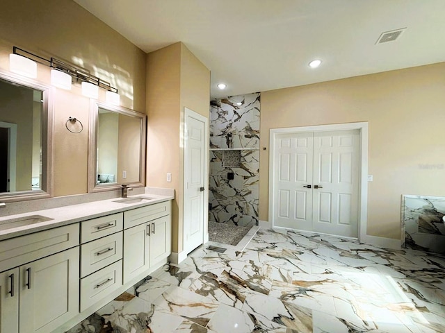 bathroom featuring a sink, visible vents, a marble finish shower, and marble finish floor