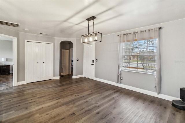 unfurnished dining area featuring dark hardwood / wood-style floors