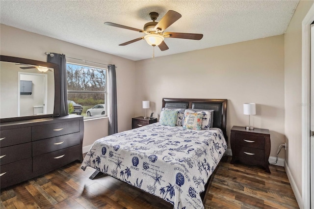 bedroom featuring a textured ceiling, dark wood-type flooring, and ceiling fan