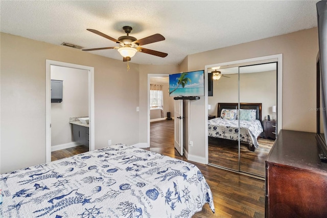 bedroom with dark wood-type flooring, ceiling fan, a closet, and a textured ceiling