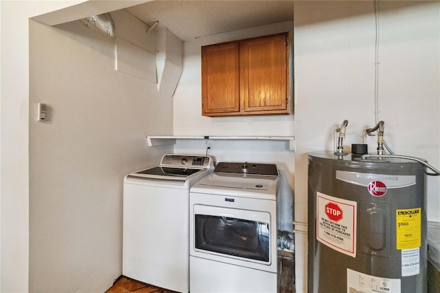 laundry room featuring cabinets, washer and clothes dryer, and water heater