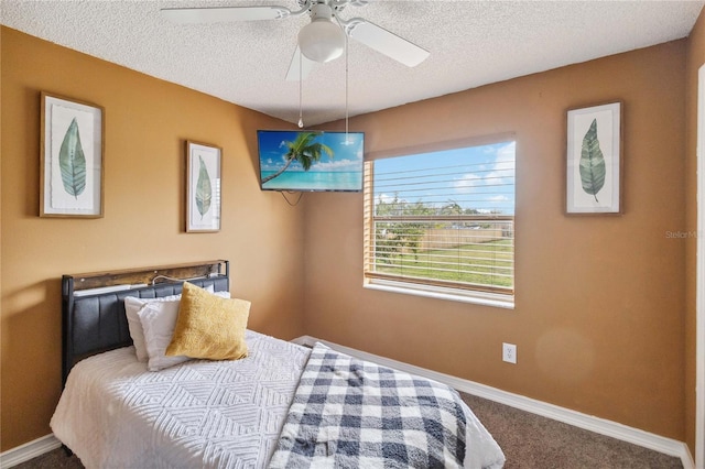 bedroom featuring a textured ceiling, carpet floors, and ceiling fan