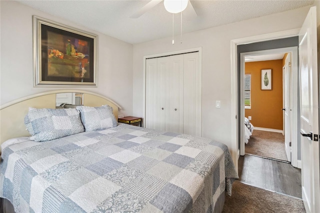 carpeted bedroom featuring a textured ceiling, ceiling fan, and a closet