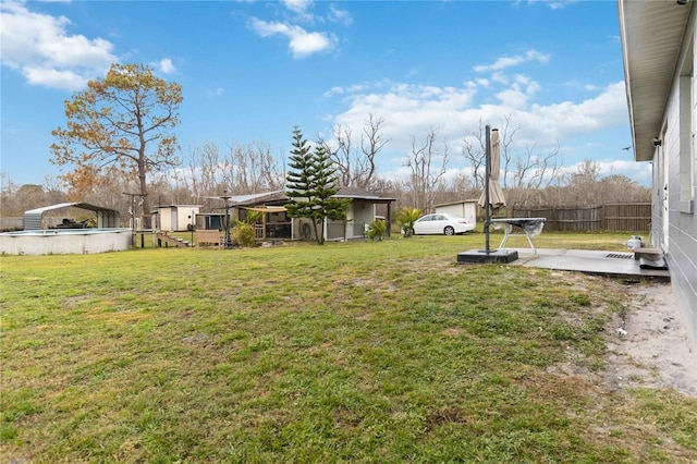 view of yard featuring a fenced in pool and a patio area