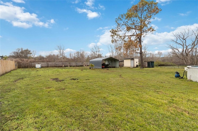 view of yard with a carport and a shed