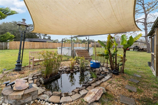 view of yard with a fenced in pool