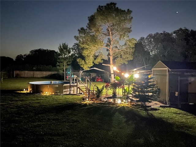 view of yard featuring a fenced in pool and a playground