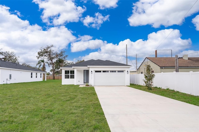 view of front of house featuring a front lawn and a garage