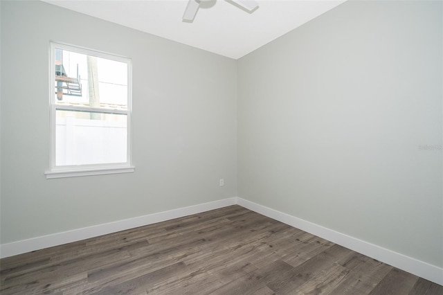 unfurnished room with dark hardwood / wood-style flooring and ceiling fan