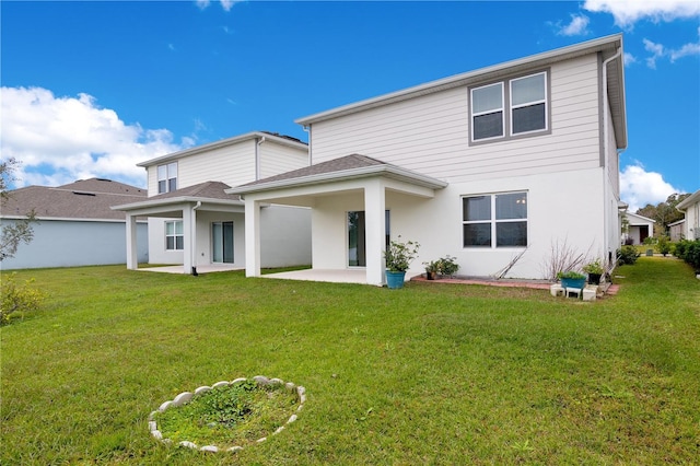 rear view of house featuring a patio area and a yard