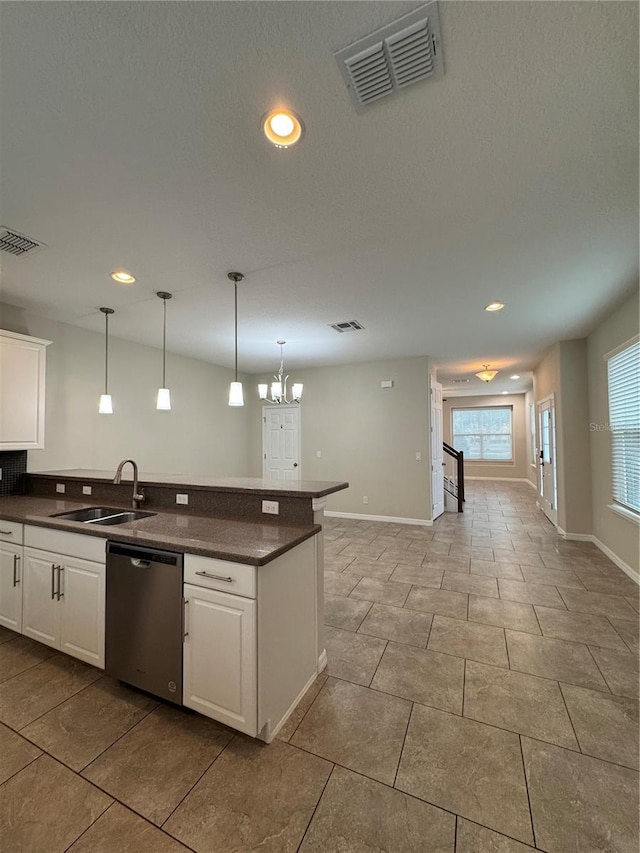 kitchen with stainless steel dishwasher, decorative light fixtures, white cabinets, and an inviting chandelier