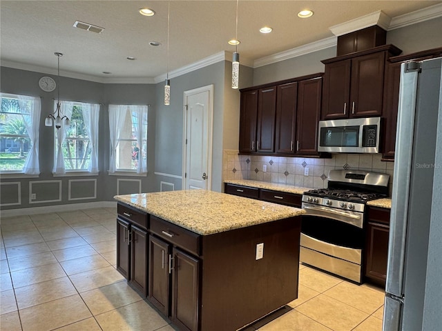 kitchen with visible vents, a center island, stainless steel appliances, dark brown cabinets, and backsplash