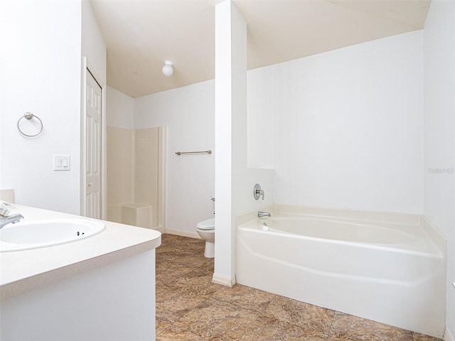 bathroom featuring a tub, toilet, and vanity