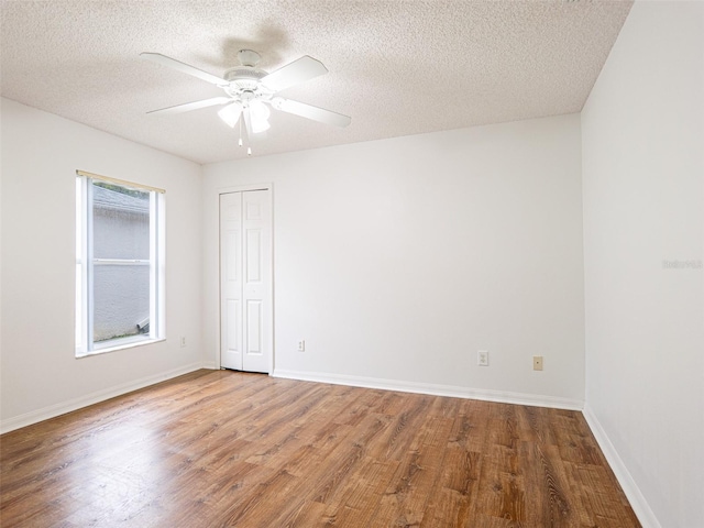 unfurnished room with a textured ceiling, ceiling fan, and hardwood / wood-style floors