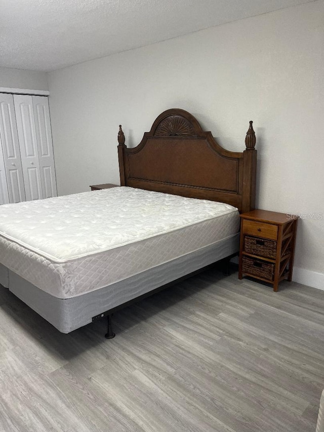 bedroom featuring light hardwood / wood-style flooring and a closet