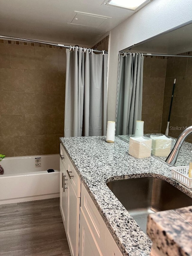 bathroom with vanity, hardwood / wood-style flooring, and shower / tub combo with curtain