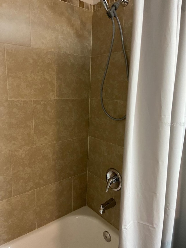 bathroom with shower / bath combination with curtain