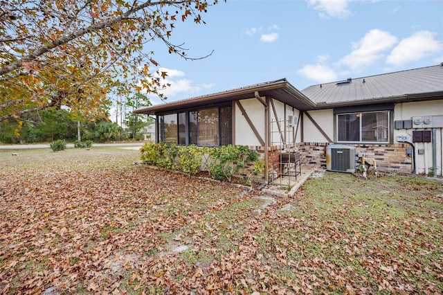 view of home's exterior featuring a lawn and cooling unit