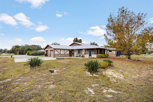 view of front of home with a front lawn and a garage