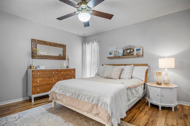 bedroom featuring a textured ceiling, hardwood / wood-style flooring, and ceiling fan