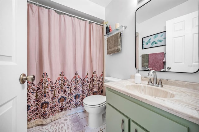 bathroom with tile patterned floors, vanity, and toilet