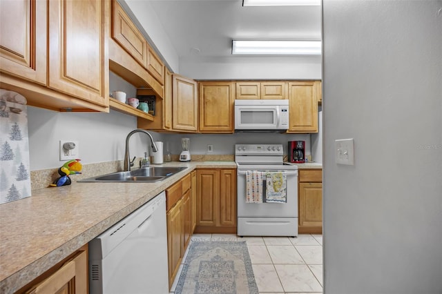 kitchen featuring light tile patterned floors, white appliances, and sink