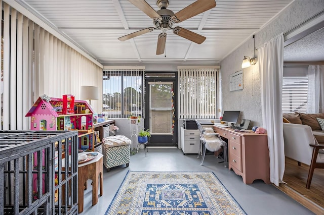 office area featuring concrete flooring and ceiling fan