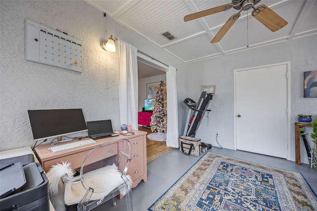 office with concrete floors and ceiling fan