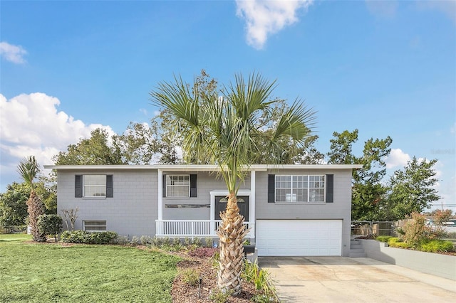 raised ranch with a front yard and a garage