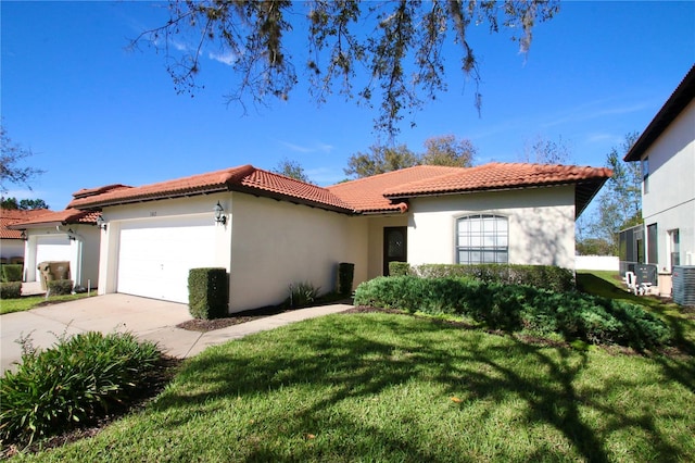 mediterranean / spanish home featuring a garage and a front lawn