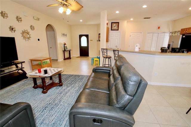 living room with ceiling fan and light tile patterned floors