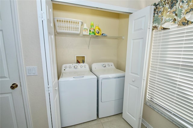 laundry room featuring light tile patterned flooring and washer and clothes dryer