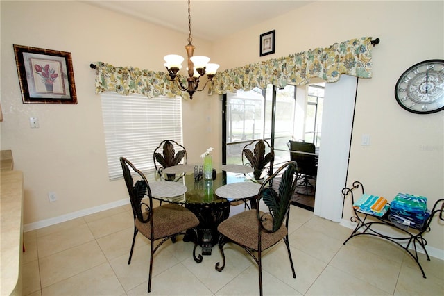 dining area with light tile patterned floors and a chandelier