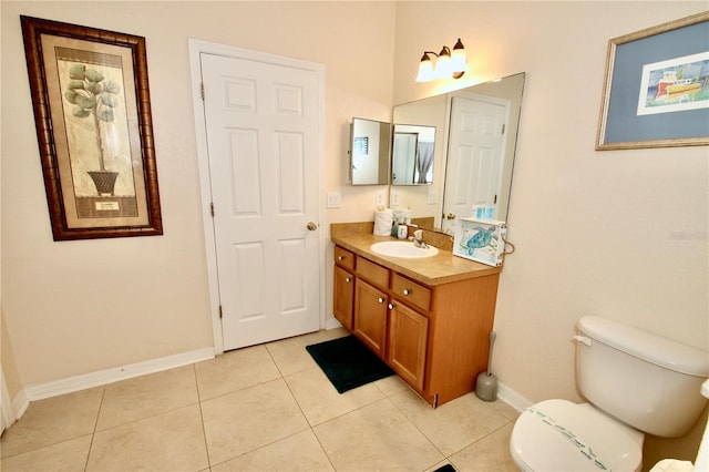 bathroom with toilet, tile patterned flooring, and vanity