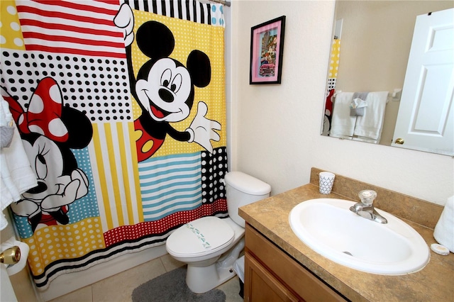 bathroom with toilet, vanity, tile patterned floors, and curtained shower