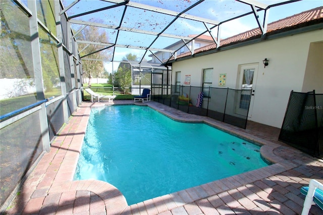 view of swimming pool with a lanai and a patio area